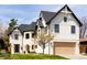 Stunning home featuring a modern Tudor design with a black roof, white brick, and a spacious two-car garage at 175 S Jasmine St, Denver, CO 80224