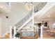 Bright foyer with winding staircase and elegant chandelier overhead at 175 S Jasmine St, Denver, CO 80224