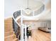 Stunning spiral staircase with white and black railings, leading to an open-concept living space at 175 S Jasmine St, Denver, CO 80224