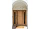 Modern wooden front door with sidelights and arched stone surround welcomes you home at 175 S Jasmine St, Denver, CO 80224