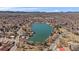 Aerial view of lakeside homes surrounding a picturesque lake, creating a tranquil, community setting at 4760 W Evans Ave, Denver, CO 80219