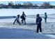 playing ice hockey on a vast frozen lake in front of lake homes at 4760 W Evans Ave, Denver, CO 80219