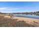 Beautiful lakeside view with a sandy beach, calm water, and clear blue skies creates a peaceful environment at 4760 W Evans Ave, Denver, CO 80219