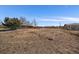 Empty lot fenced off and bordered by trees with the opportunity to build a custom dream home at 4760 W Evans Ave, Denver, CO 80219