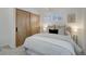 Well-lit bedroom with light wood sliding doors and carpeted floors at 4145 Otis St, Wheat Ridge, CO 80033