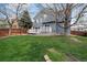 Back yard featuring a well-maintained lawn, a two-story house, and a wooden fence at 5486 S Cathay Way, Centennial, CO 80015