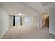 Finished basement featuring carpeted floors, a window, a door, and access to the stairs at 5486 S Cathay Way, Centennial, CO 80015