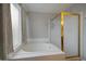 Bright bathroom featuring a soaking tub with gold fixtures and a glass shower at 5486 S Cathay Way, Centennial, CO 80015