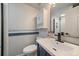 Bathroom with a white vanity, vessel sink, modern faucet, storage cabinet, and white tiled shower at 5486 S Cathay Way, Centennial, CO 80015