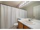 Bathroom featuring a single sink vanity, a large mirror, a shower with a curtain, and a toilet at 5486 S Cathay Way, Centennial, CO 80015