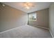 Bright bedroom featuring neutral walls, carpet, a ceiling fan, and a window offering natural light at 5486 S Cathay Way, Centennial, CO 80015