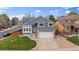 Charming two-story home with a well-manicured lawn and a two-car garage at 5486 S Cathay Way, Centennial, CO 80015