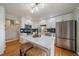 Modern kitchen featuring white cabinets, stainless steel appliances, and a central island at 5486 S Cathay Way, Centennial, CO 80015