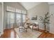 Bright living room featuring large windows, vaulted ceilings, and hardwood floors at 5486 S Cathay Way, Centennial, CO 80015