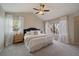 Main bedroom with vaulted ceilings, natural light, neutral carpeting, and two windows with white curtains at 5486 S Cathay Way, Centennial, CO 80015