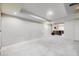 Unfinished basement area with carpeted floor, drop ceiling, and bright lighting at 3596 S Depew St # 2, Lakewood, CO 80235