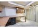 Unfinished basement space with a built in desk area, cabinets and storage at 3596 S Depew St # 2, Lakewood, CO 80235