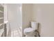 Bathroom with tiled floors, toilet and shower, with white cabinets and vanity at 3596 S Depew St # 2, Lakewood, CO 80235