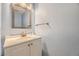 Clean half bathroom features a white vanity, modern sink, and a blue painted wall at 3596 S Depew St # 2, Lakewood, CO 80235