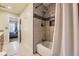 Clean bathroom with tiled shower, tub, and a view into the bedroom at 3596 S Depew St # 2, Lakewood, CO 80235