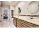 Bright bathroom features a double sink vanity, stylish mirrors, and tiled floors at 3596 S Depew St # 2, Lakewood, CO 80235