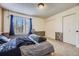 Bedroom featuring large window, carpeted floors and ample closet space at 3596 S Depew St # 2, Lakewood, CO 80235