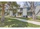 Charming exterior view of townhomes, highlighting the private patio space and lush green lawn at 3596 S Depew St # 2, Lakewood, CO 80235