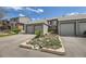 Close up of the townhouse featuring a well-kept lawn and lovely green siding at 3596 S Depew St # 2, Lakewood, CO 80235