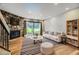 Bright living room features a stone fireplace and sliding doors to a green outdoor space at 3596 S Depew St # 2, Lakewood, CO 80235