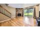 Inviting living room with stone fireplace, hardwood floors, and large sliding glass doors at 3596 S Depew St # 2, Lakewood, CO 80235