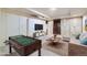 Virtual staging: Finished basement with lounge area and a foosball table at 3596 S Depew St # 2, Lakewood, CO 80235