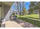 View of the patio with a grill and outdoor furniture, showcasing a well-maintained lawn and greenery at 3596 S Depew St # 2, Lakewood, CO 80235