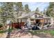 Spacious backyard area with a play structure, adjacent to the house's exterior, and a peaceful environment at 8795 Rudd Rd, Evergreen, CO 80439