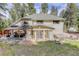 Home exterior featuring a sunroom, gazebo, and hot tub in the backyard at 8795 Rudd Rd, Evergreen, CO 80439