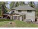 The backyard has a hot tub and gazebo, with the home's exterior featuring a sunroom at 8795 Rudd Rd, Evergreen, CO 80439