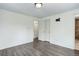 Large, empty bedroom with two closet doors, a wood-look floor, and views of the adjacent bathroom at 8795 Rudd Rd, Evergreen, CO 80439