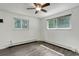 Empty bedroom with hardwood floors, white walls, and two windows providing ample natural light at 8795 Rudd Rd, Evergreen, CO 80439