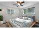 Staged bedroom with two windows providing natural light and a ceiling fan for added comfort at 8795 Rudd Rd, Evergreen, CO 80439