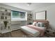 Staged bedroom with custom white built-in shelving and storage, hardwood floors, and filled with natural light at 8795 Rudd Rd, Evergreen, CO 80439