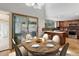 Elegant dining room with views to the back deck, gazebo, and lush backyard at 8795 Rudd Rd, Evergreen, CO 80439
