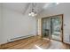 Bright dining room with hardwood floors and a view to the gazebo at 8795 Rudd Rd, Evergreen, CO 80439