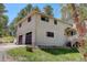 A well-maintained home featuring an attached two-car garage and charming exterior details at 8795 Rudd Rd, Evergreen, CO 80439
