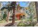 Beautiful exterior view of home, highlighting the deck and the surrounding nature creating a serene atmosphere at 8795 Rudd Rd, Evergreen, CO 80439
