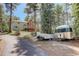 Scenic shot of the home, trailers, and lush surrounding landscape offering a glimpse of the outdoor lifestyle at 8795 Rudd Rd, Evergreen, CO 80439
