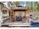Inviting outdoor gazebo with comfortable seating and wooded views creating a relaxing retreat at 8795 Rudd Rd, Evergreen, CO 80439