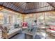 Cozy gazebo featuring comfortable seating, a fire table, and scenic woodland views at 8795 Rudd Rd, Evergreen, CO 80439