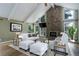 Spacious living room with stone fireplace, vaulted ceilings, and abundant natural light at 8795 Rudd Rd, Evergreen, CO 80439