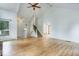 Bright and airy living room with hardwood floors and staircase at 8795 Rudd Rd, Evergreen, CO 80439