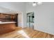 Open-concept layout with hardwood floors, connecting the living room and kitchen areas at 8795 Rudd Rd, Evergreen, CO 80439