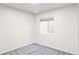 Bright and airy basement bedroom with grey carpet and a window at 2469 S Acoma St, Denver, CO 80223